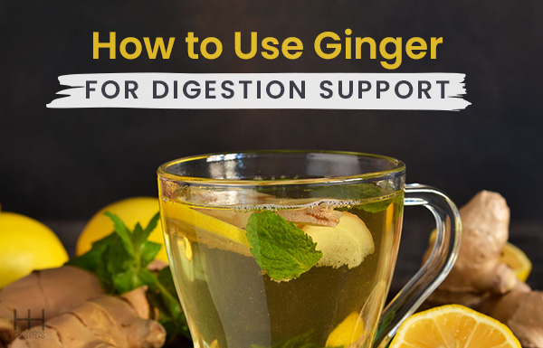 A glass of tea containing mint, lemon, and ginger for digestion support.