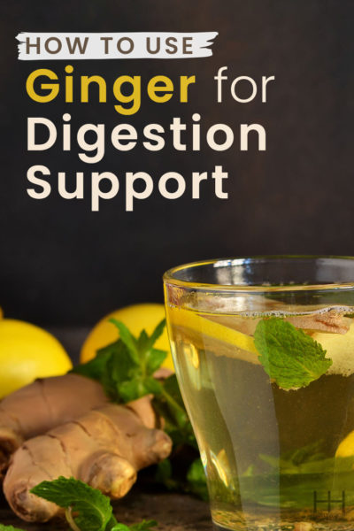 A glass of tea containing mint, lemon, and ginger for digestion support.