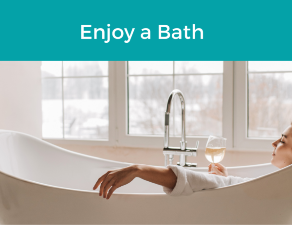 image of a woman with a glass of wine in the bath under the title "Enjoy a Bath"